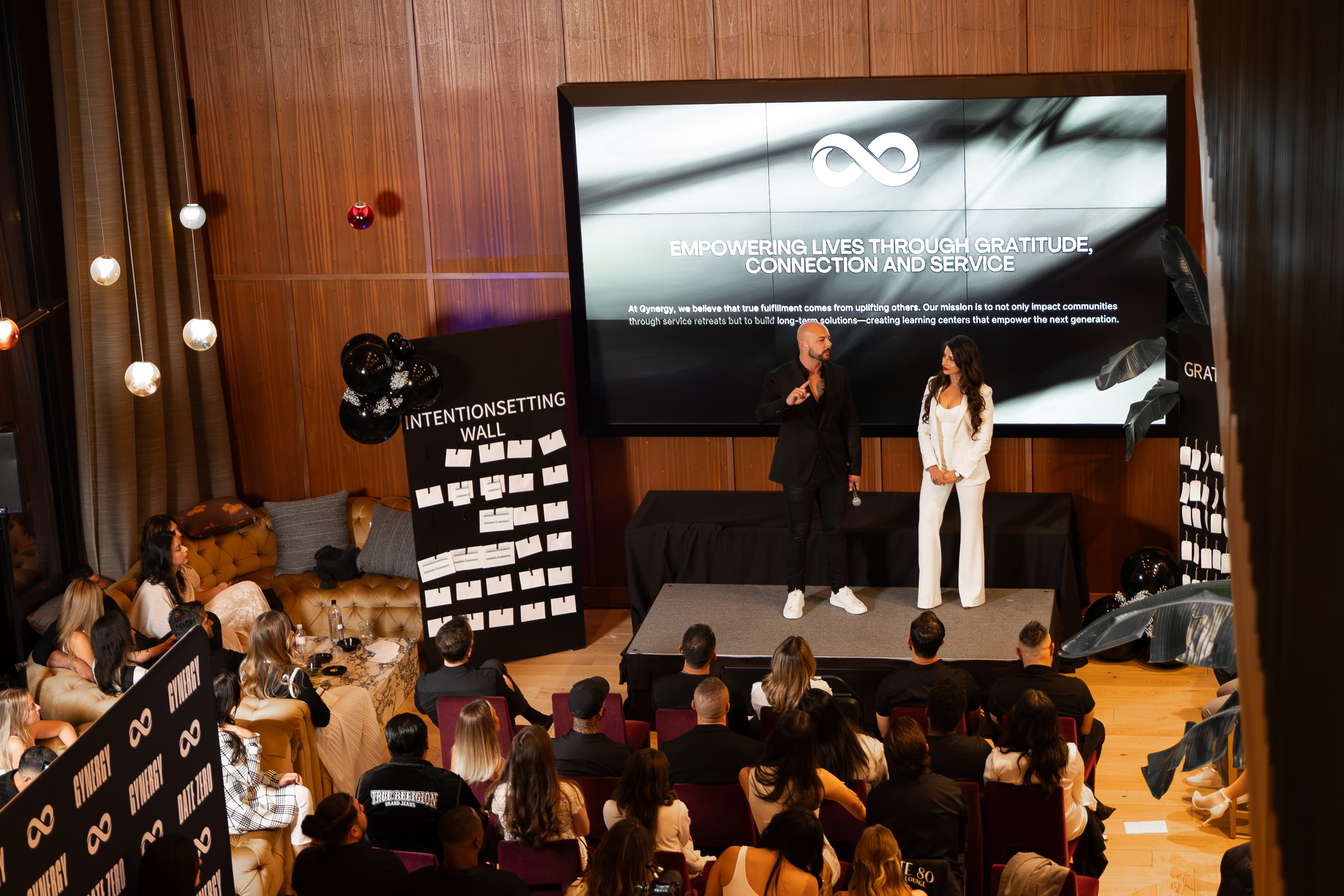 Garin Heslop delivering a keynote on stage at a GYNERGY event