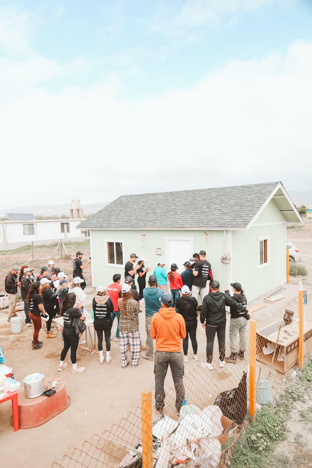 Handing the keys to the family in front of their new home