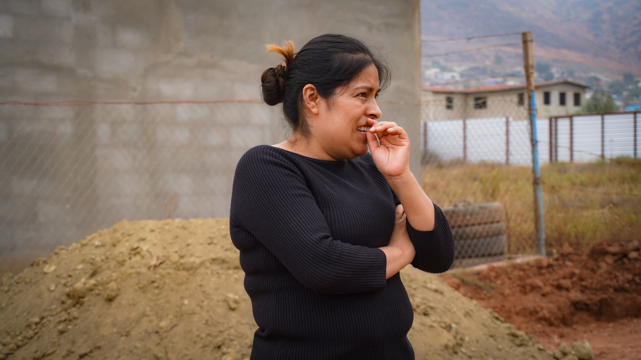 The mother of the Pérez Vázquez family standing at the build site in Ensenada, Mexico